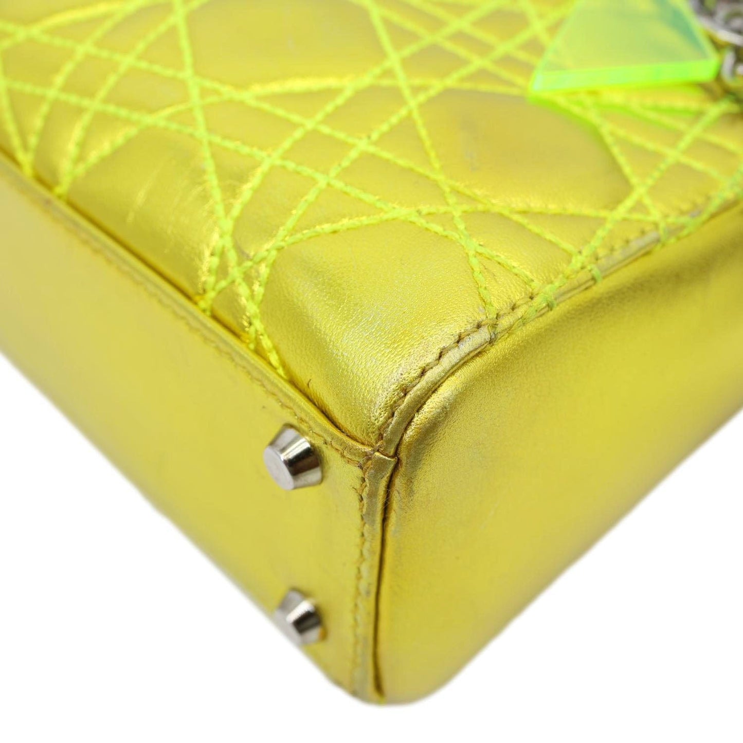 Close-up of CHRISTIAN DIOR Lady Dior Mini Metallic Leather Shoulder Bag Neon Yellow with Cannage stitching details.
