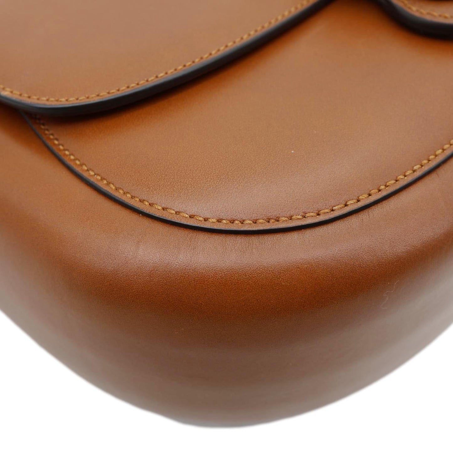Close-up of brown GUCCI Logo Small Embossed Calfskin Leather Shoulder Bag 679540 with relaxed fit style.