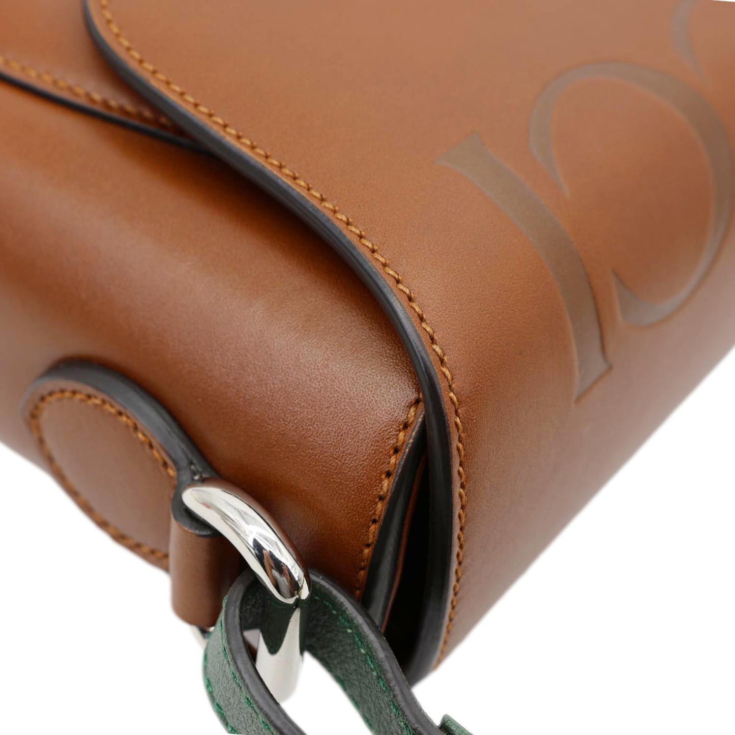 Close-up of GUCCI Logo Small Embossed Calfskin Leather Shoulder Bag Brown 679540 with detailed leather texture and logo design.