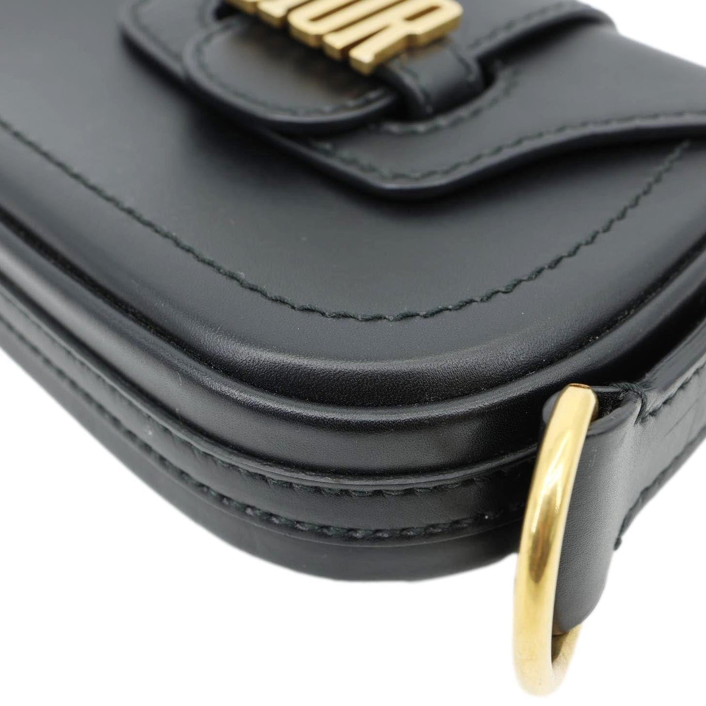 Close-up of CHRISTIAN DIOR D Fence Small Calfskin Leather Saddle Bag Black with gold buckle detail and relaxed fit design.