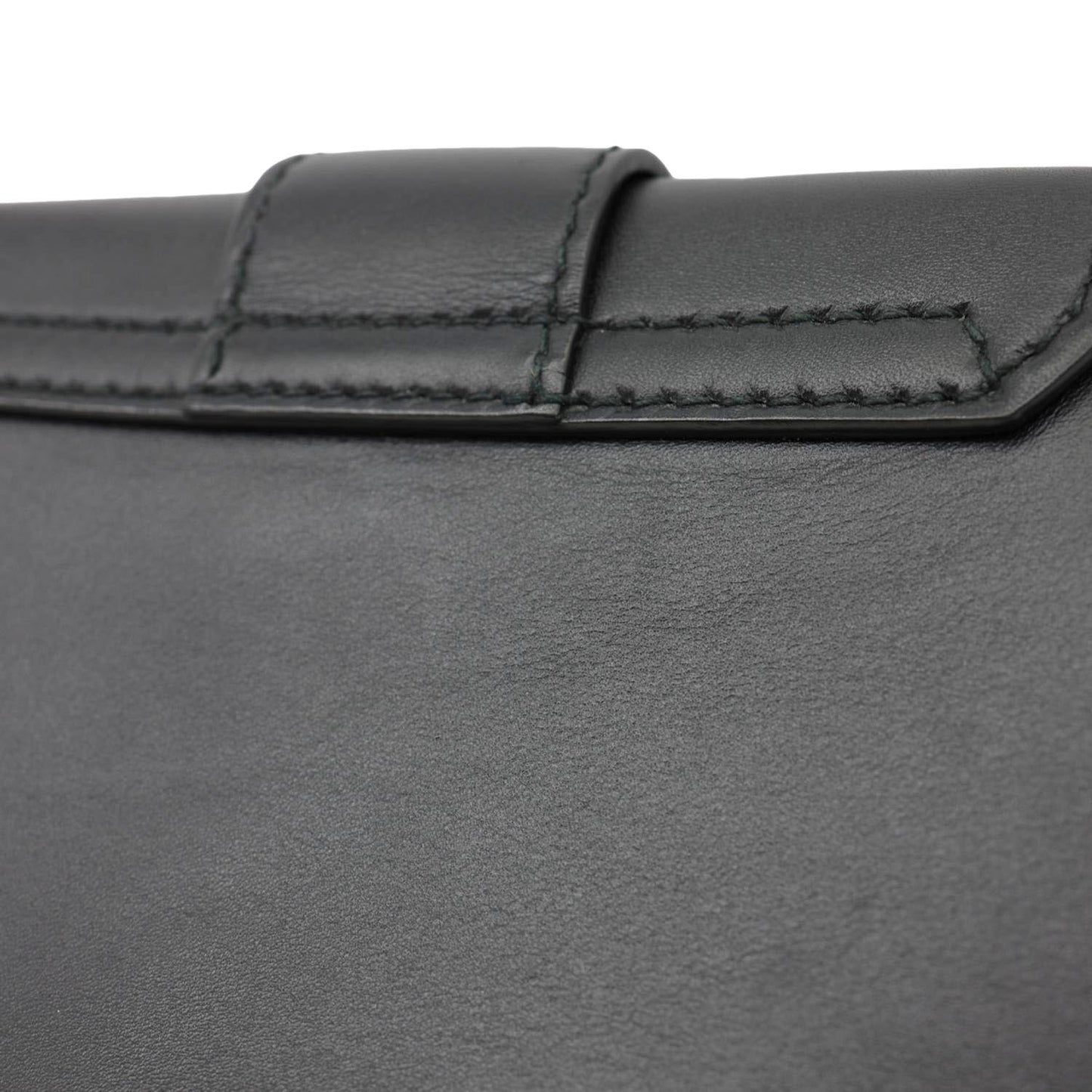 Close-up of CHRISTIAN DIOR D Fence Small Calfskin Leather Saddle Bag Black featuring smooth leather texture and stitching detail.
