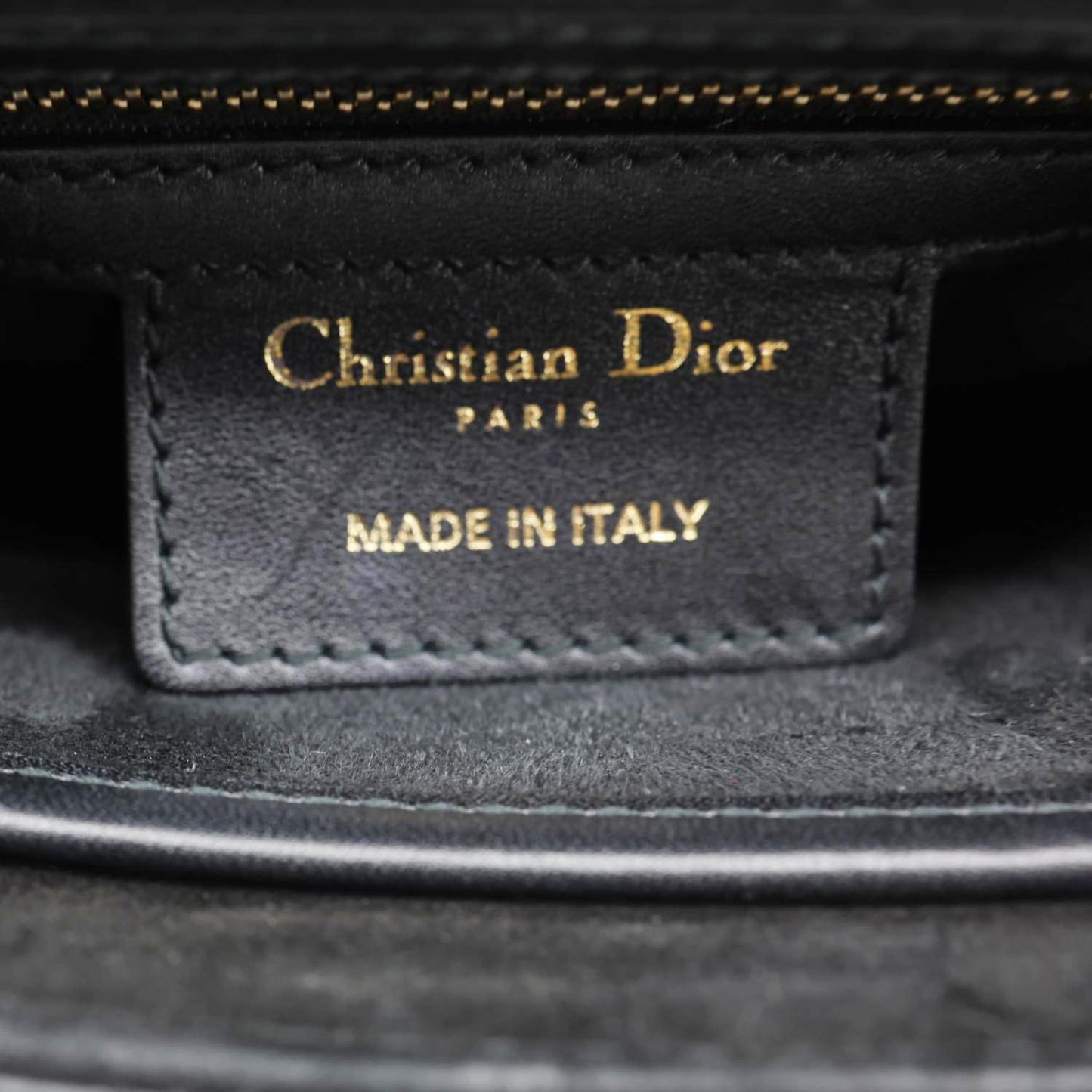 Label inside CHRISTIAN DIOR D Fence Small Calfskin Leather Saddle Bag Black showing 'MADE IN ITALY' stamp.