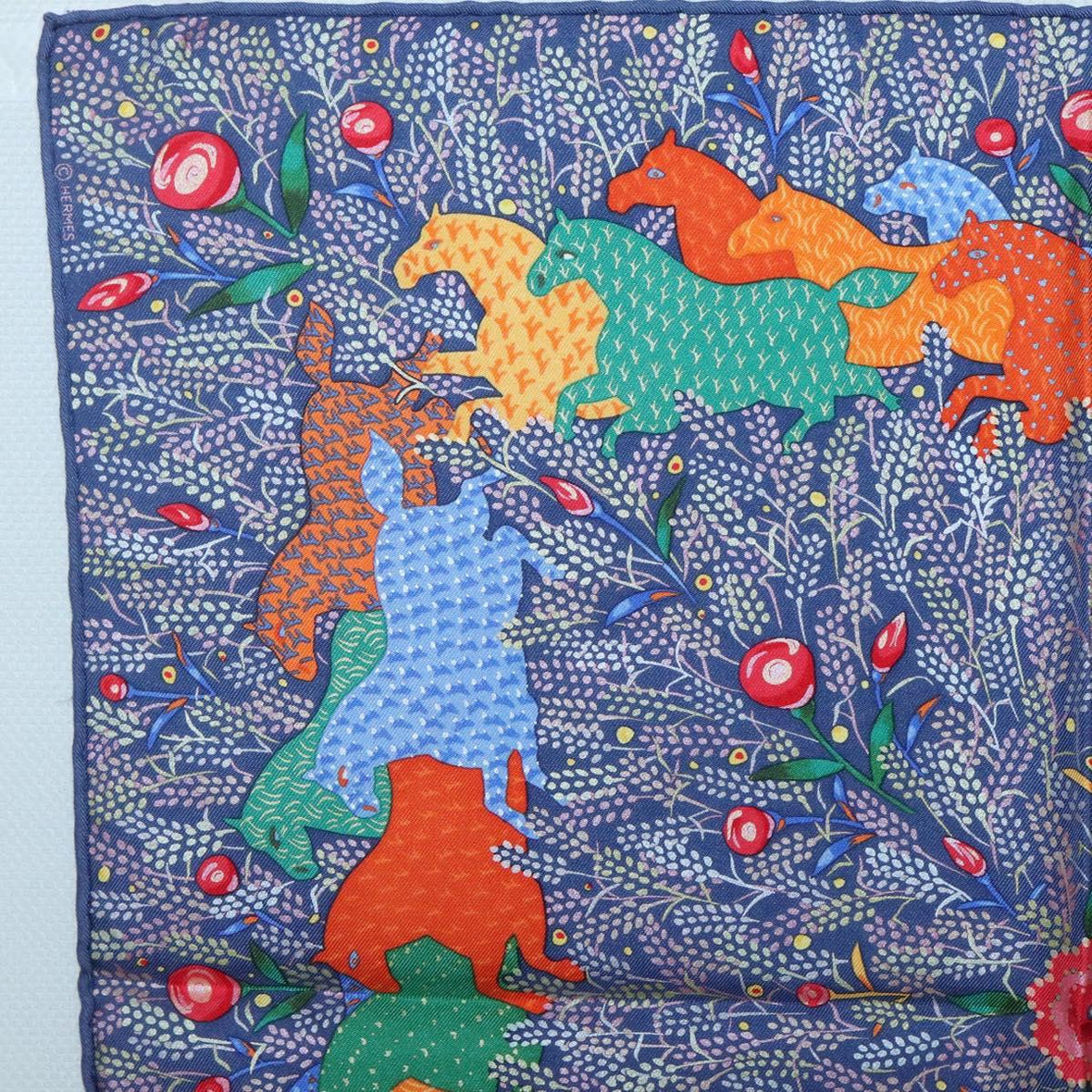 Authentic vintage Hermes silk scarf featuring colorful unicorn design, relaxed fit graphic tee, and hoodie style elegance.