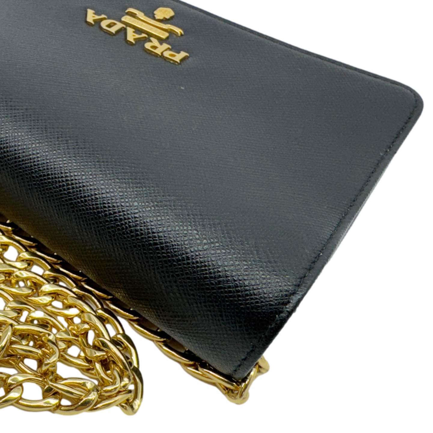PRADA Saffiano Lux Chain Crossbody Bag Black with gold-tone chain and logo, featuring sleek textured leather. Compact and elegant design.