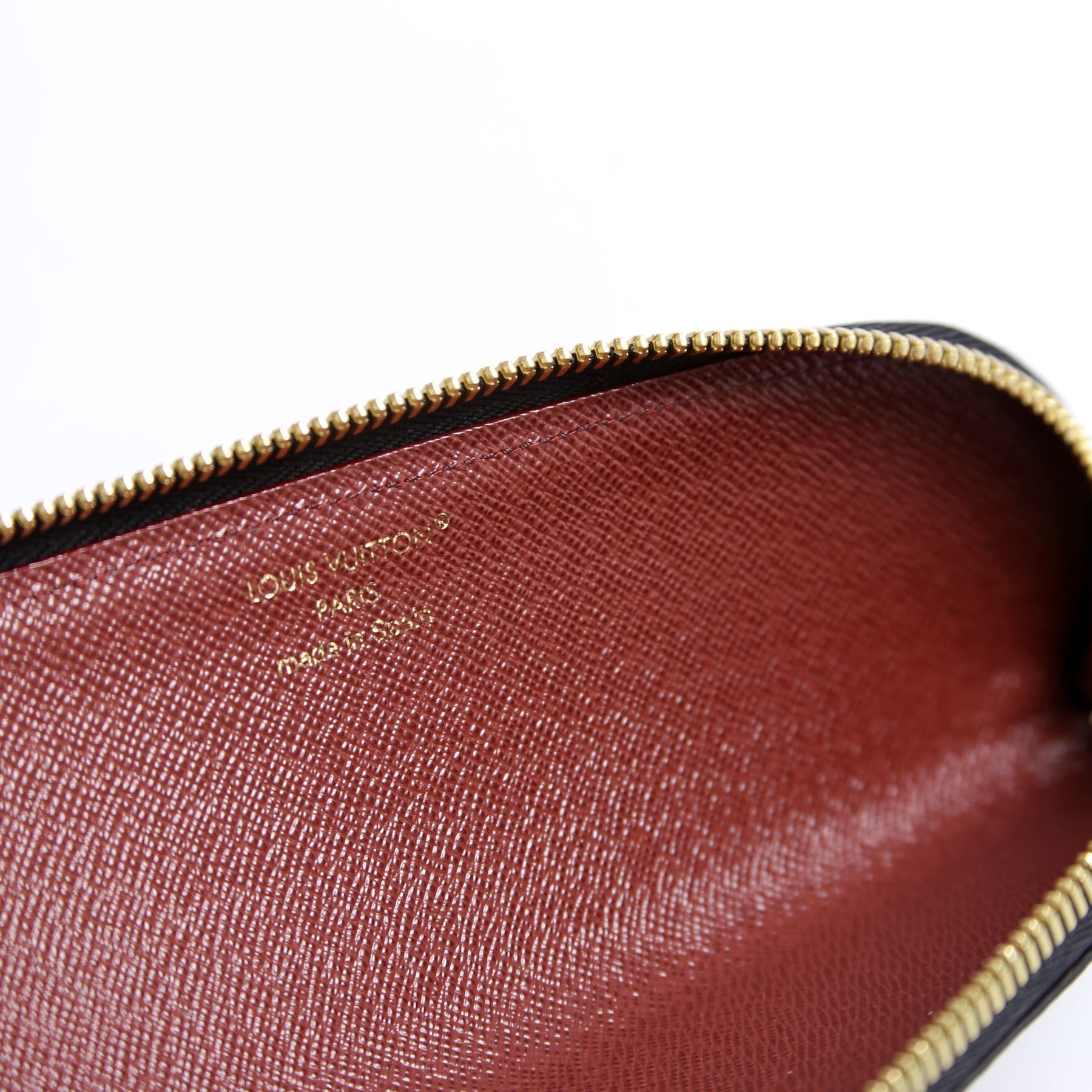 Interior view of the Louis Vuitton Come and Play With Me Charlotte Pencil Pouch Reverse Monogram showing zipper and brown lining.