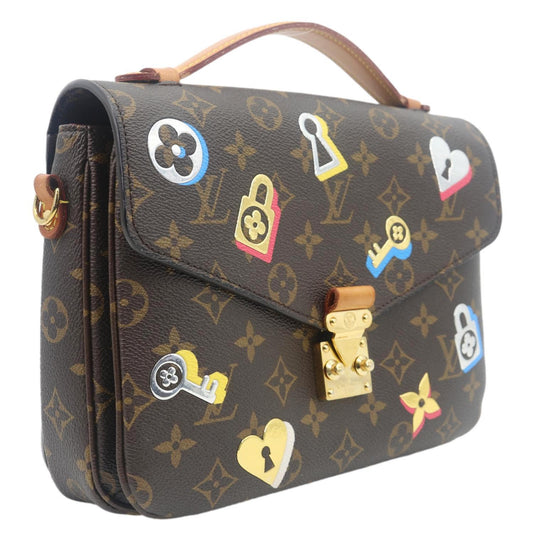 LOUIS VUITTON Lovelock Metis Pochette Patches Monogram Canvas Crossbody Bag Brown with playful patches, compact design.