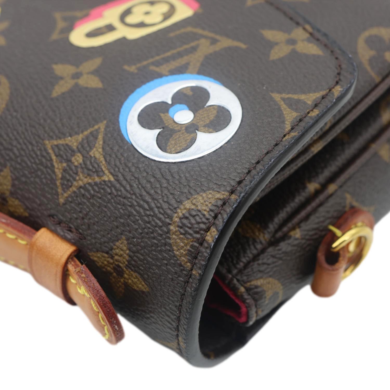Close-up of LOUIS VUITTON Lovelock Metis Pochette Patches Monogram Canvas Crossbody Bag Brown with playful patch details.