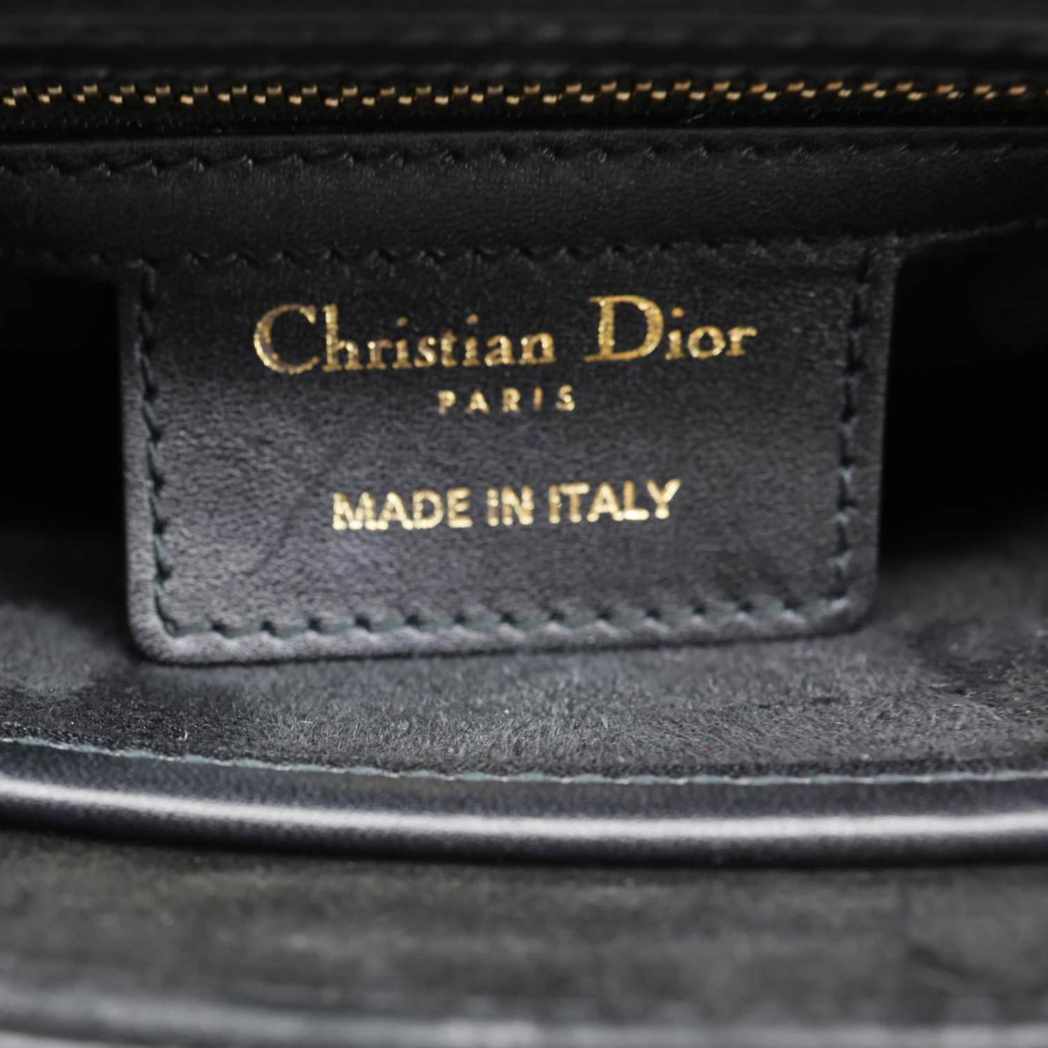 Label inside CHRISTIAN DIOR D Fence Small Calfskin Leather Saddle Bag Black showing 'MADE IN ITALY' stamp.