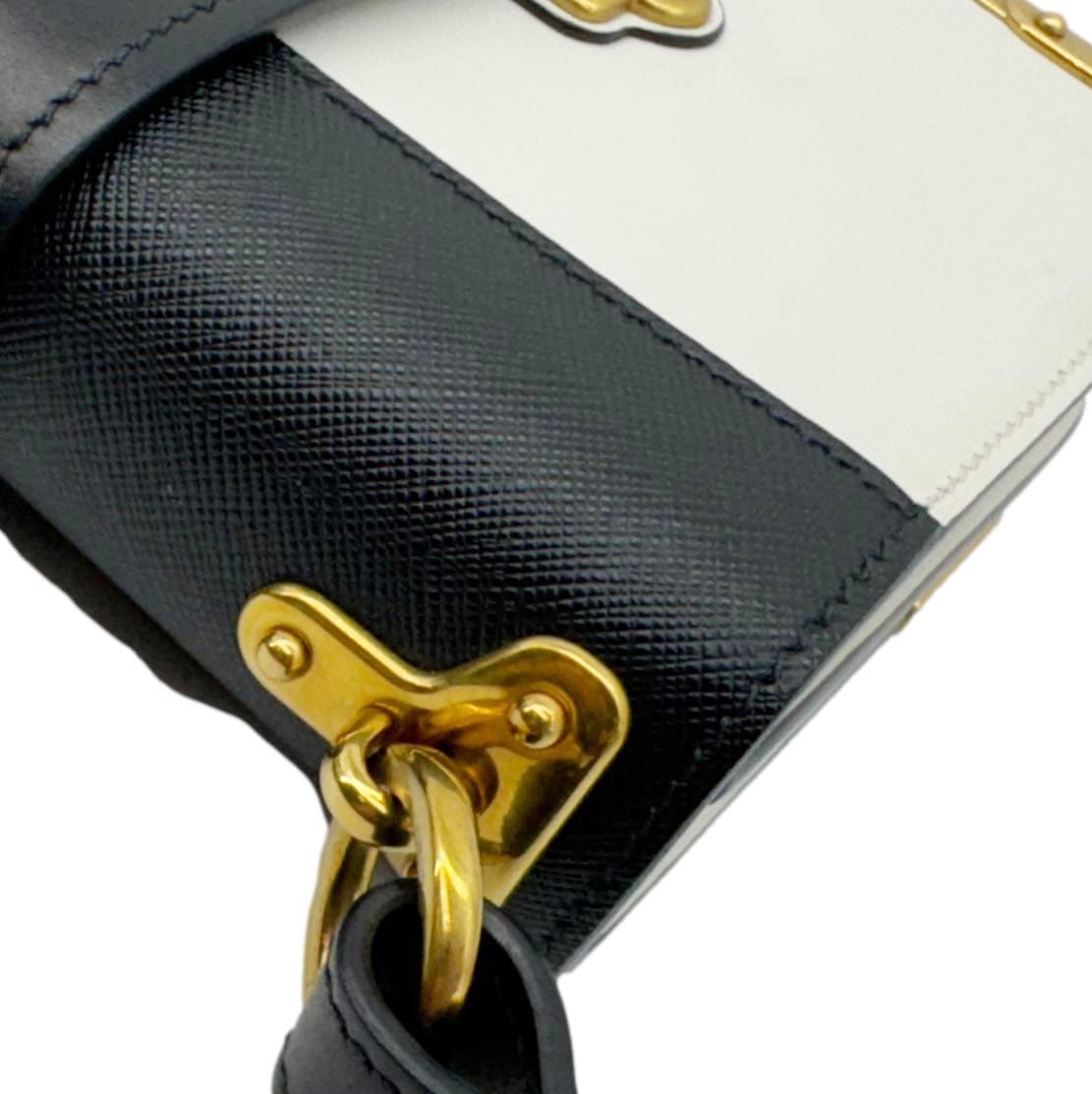 Close-up of PRADA Cahier City Large Calf Saffiano Leather Shoulder Bag White with antique gold-tone hardware and book-inspired design.